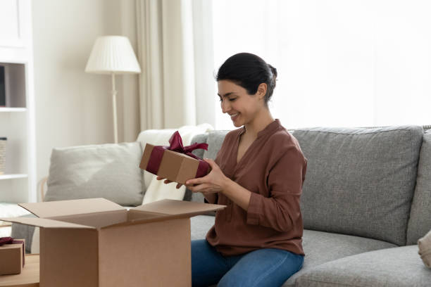 istock Happy Indian woman unbox parcel with present surprise 1333547972