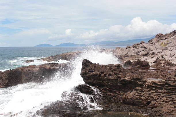 istock The waves hit the rocks. 1333549031