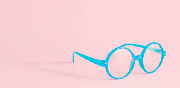 istock Blue glasses on pastel pink background with copy space, banner 1333550472