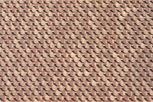 background of scalloped red clay roofing tiles
