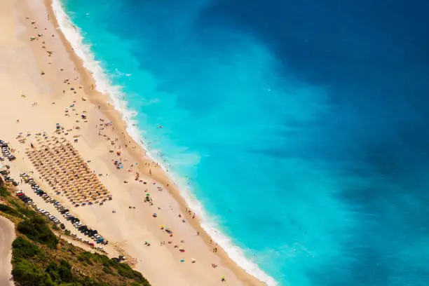 Photo of Top view at Myrtos Beach with turquoise and blue Ionian Sea water. Summer scenery of famous and extremely popular travel destination in Cephalonia, Greece, Europe