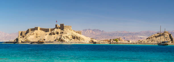 Medieval fortress of Sultan Salah ad-Din in Taba, Gulf of Aqaba. Old fortress of sultan Salah El Din in Taba - ancient landmarks of an arabic culture on Sinai Peninsula, Egypt. Panorama of medieval Citadel of Saladin on the Pharaoh's Island in the Gulf of Aqaba. taba stock pictures, royalty-free photos & images