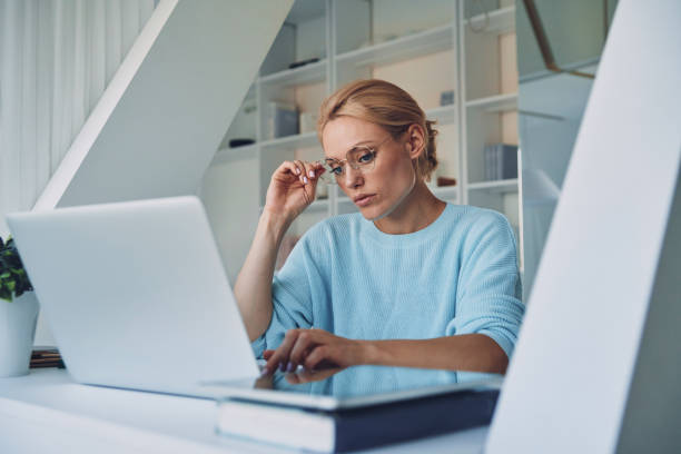 istock Beautiful young woman using laptop 1333554631
