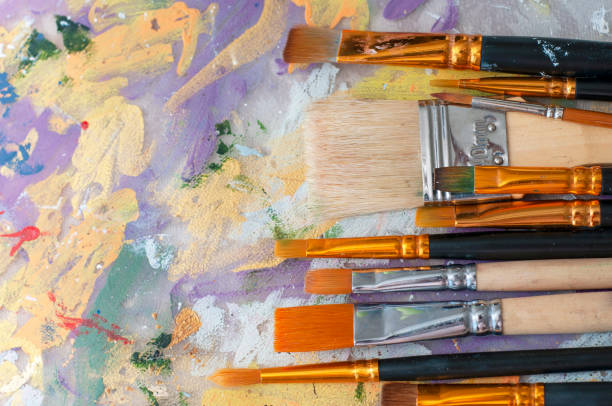 istock Brushes on the artist's canvas are covered with paints 1333555259