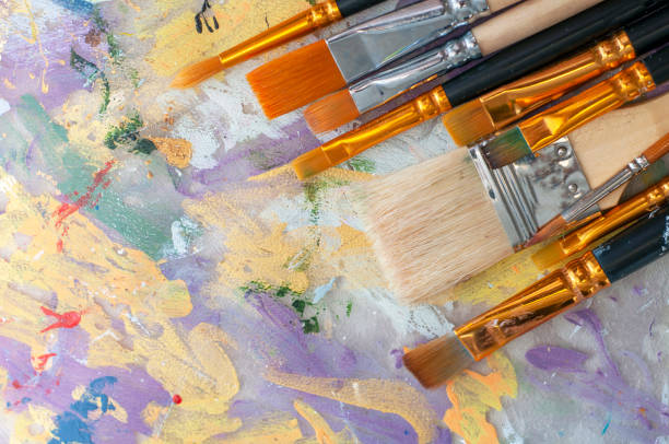 istock Brushes on the artist's canvas are covered with paints 1333555261