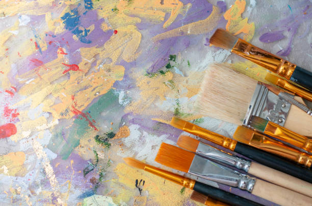 istock Brushes on the artist's canvas are covered with paints 1333555265