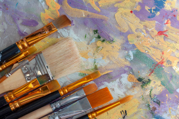 istock Brushes on the artist's canvas are covered with paints 1333555268