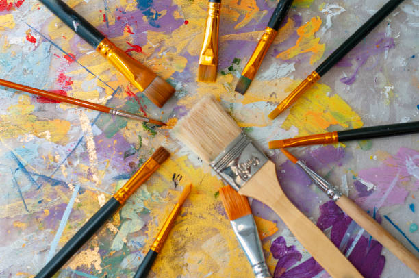 istock Brushes on the artist's canvas are covered with paints 1333555270