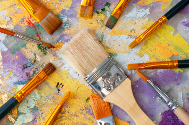 istock Brushes on the artist's canvas are covered with paints 1333555273