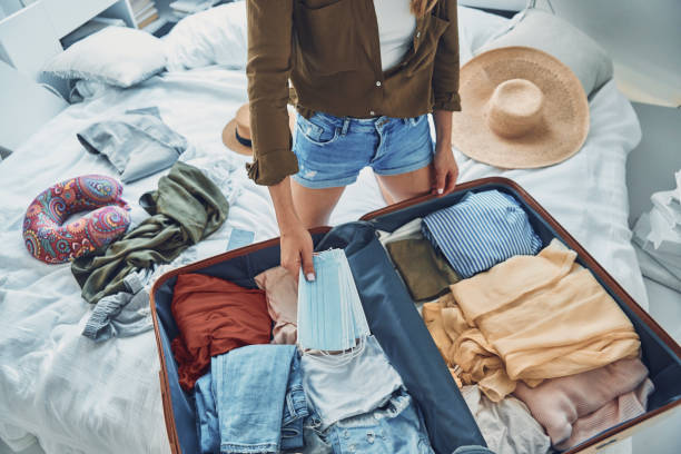 istock Beautiful young woman packing luggage 1333555743