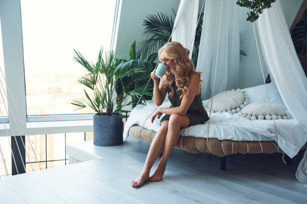 istock Attractive young smiling woman enjoying hot drink 1333558556