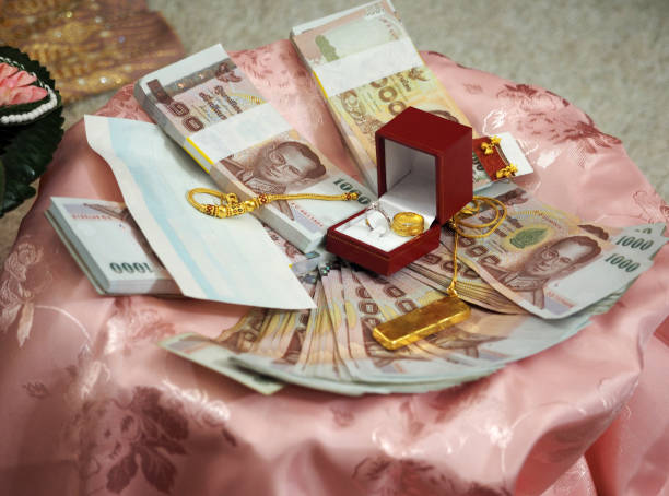 istock Dowry; golds and banknotes on pink satin fabric 1333560059