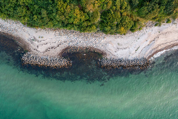 Aerial View of coastline in North Zealand, Denmark Villingebaek, Denmark - July 23, 2021: Aerial view of coastal protection in North Zealand eroded stock pictures, royalty-free photos & images
