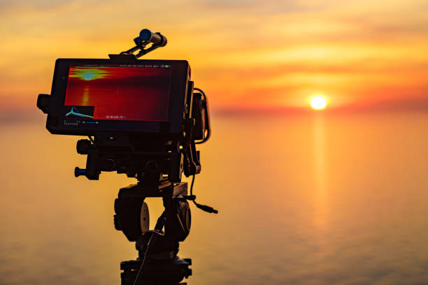 istock Camera taking picture of sunset over sea 1333565941