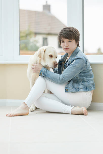 istock Young lady in her conservatory with her dog 1333566047