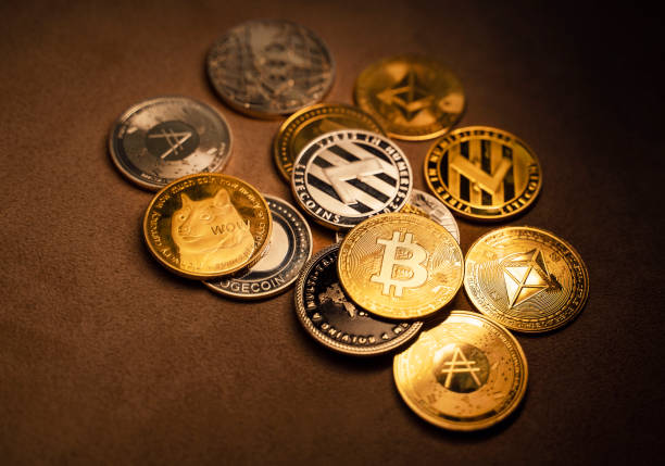 Close up shot of Bitcoin and alt coins cryptocurrency over brown background stock photo