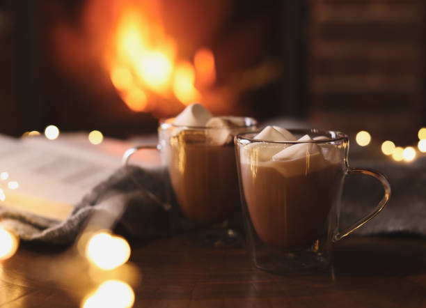 istock Delicious sweet cocoa with marshmallows and blurred fireplace on background 1333575339