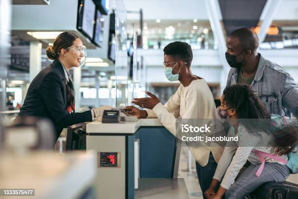 African Family At Airport Checkin Desk With Face Masks Stock Photo - Download Image Now