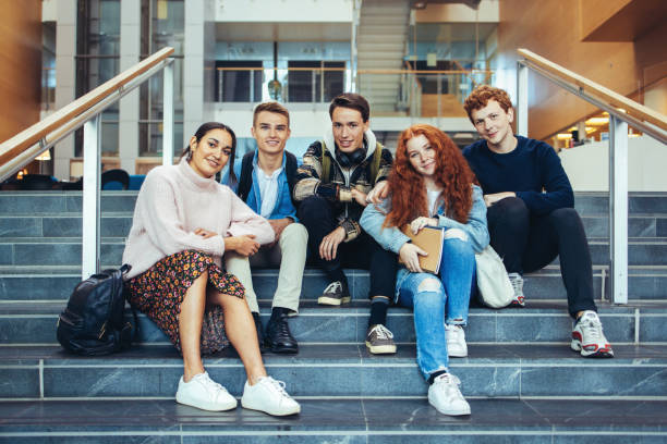 istock Smiling young people on college steps 1333575744