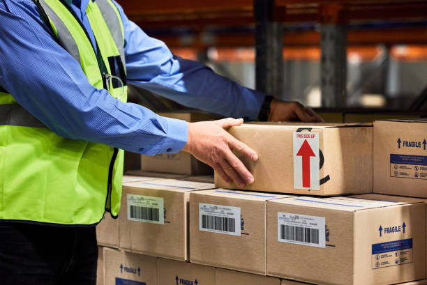 istock Shot of a unrecognizable man packing boxes in a warehouse 1333576617