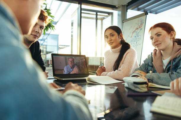 istock Students having video call meeting with professor in college 1333576629