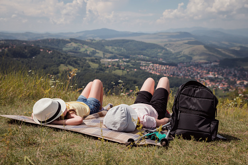 Girls resting on the top of the mountain after a hike