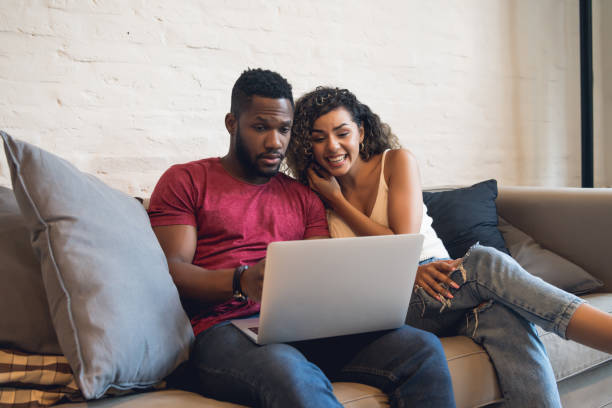 istock Young couple using a laptop together at home. 1333585698