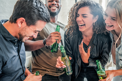 Group of friends having fun while drinking beer together. Friends concept.