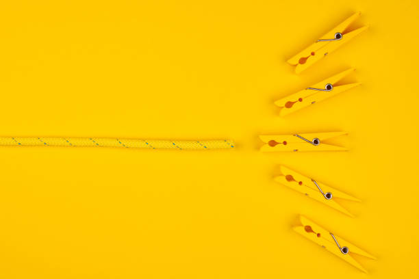 Yellow clothespins and rope. Catch your luck. Yellow background. Lucky break concept.