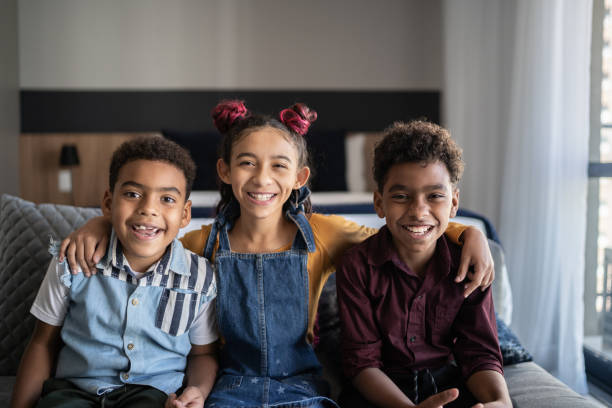 istock Portrait of siblings embracing at home 1333589638