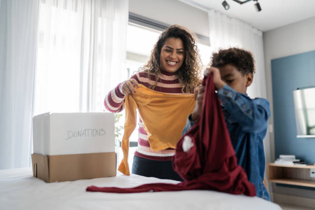 istock Mother and son sorting clothes for donation at home 1333590299