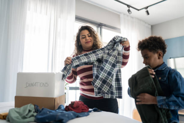 istock Mother and son sorting clothes for donation at home 1333590304