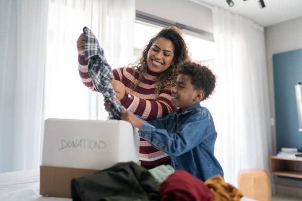 istock Mother and son sorting clothes for donation at home 1333590309
