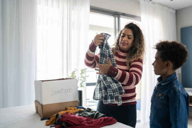 istock Mother and son sorting clothes for donation at home 1333590322