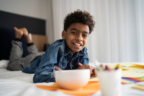 istock Portrait of boy drawing at home 1333590340