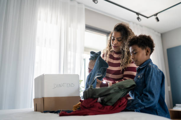 istock Mother and son sorting clothes for donation at home 1333590344