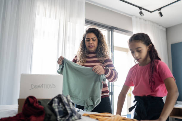 istock Mother and daughter sorting clothes for donation at home 1333590369