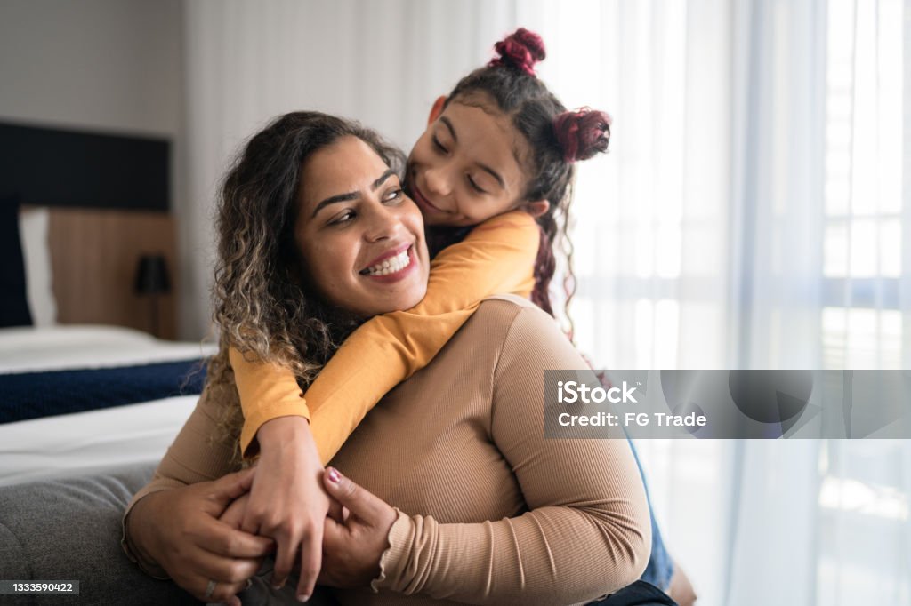 Happy mother and daughter sharing bonding moment at home Latin American and Hispanic Ethnicity Stock Photo