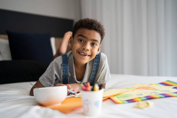 istock Portrait of boy drawing at home 1333590426