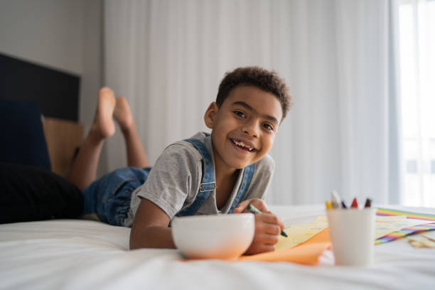 istock Portrait of boy drawing at home 1333590616