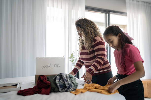 istock Mother and daughter sorting clothes for donation at home 1333590720