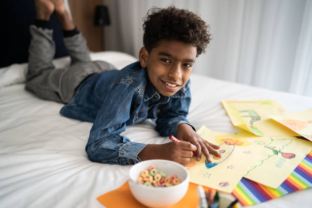 istock Portrait of boy drawing at home 1333590722