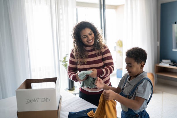istock Mother and son sorting clothes for donation at home 1333590761