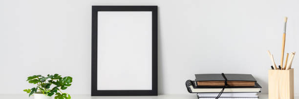 istock Desk arrangement. Workplace. Mockup frame. Empty wall of copy space. Books and notebooks on the desk. Banner. 1333593770