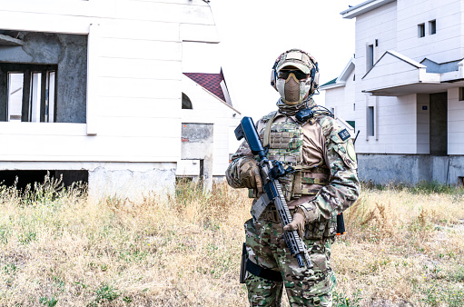 Horizontal photo of soldier using automatic weapon