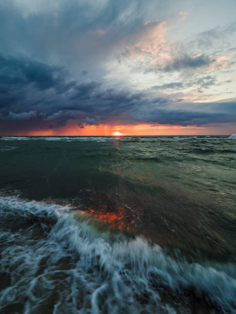 A view of a stormy Baltic Sea in Uniescie, Poland at the sunset