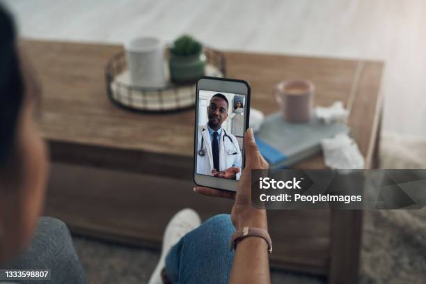 Shot Of An Unrecognizable Person On A Videocall With A Doctor Stock Photo - Download Image Now