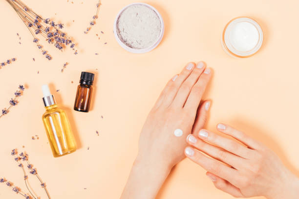 istock Top view female hands applying cosmetic moisturizer to skin 1333603909