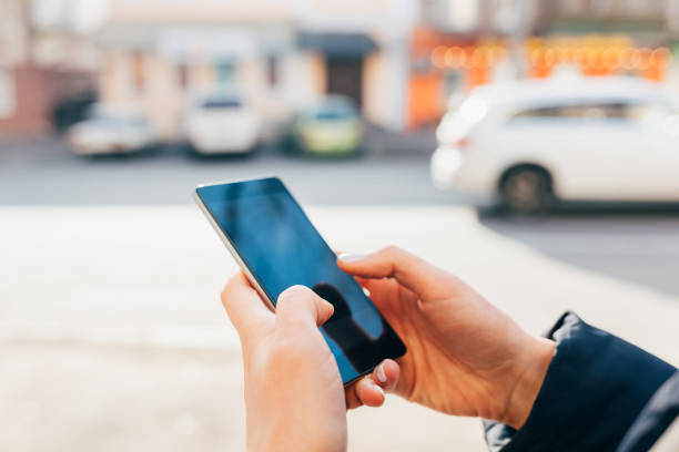 istock Woman holding mobile phone in her hands 1333603983