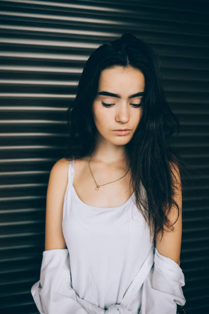 istock Thoughtful brunette young woman wearing white top 1333603997